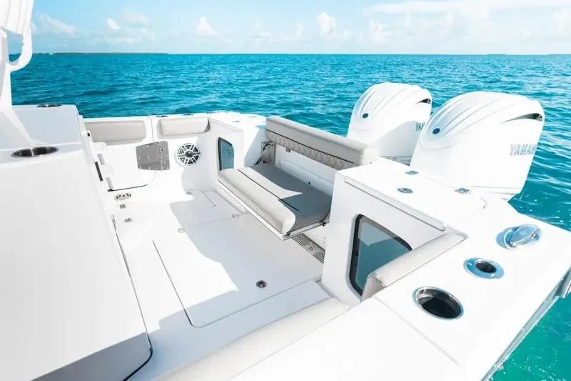 Slide: The Image of 2026 Sportsman Open 282 Center Console boat on clear blue water, featuring dual engines. - 24