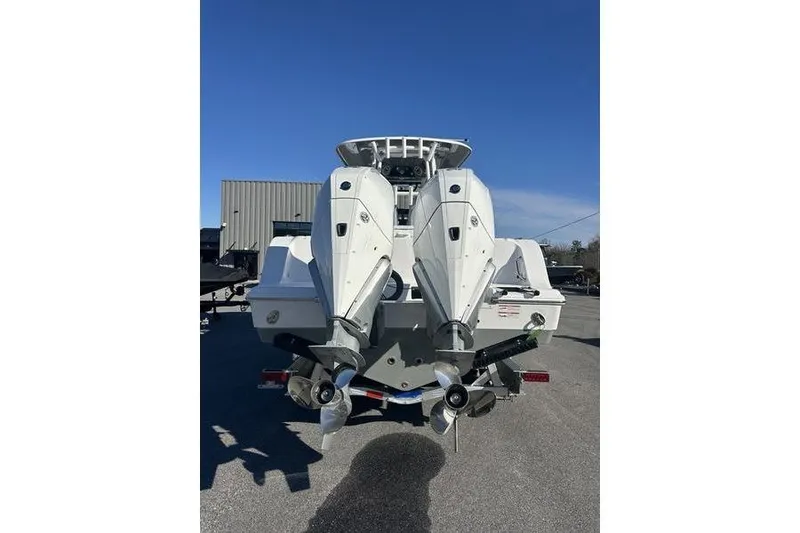 Slide: The Image of 2026 Sportsman Open 282 Center Console boat with dual outboard engines. - 25