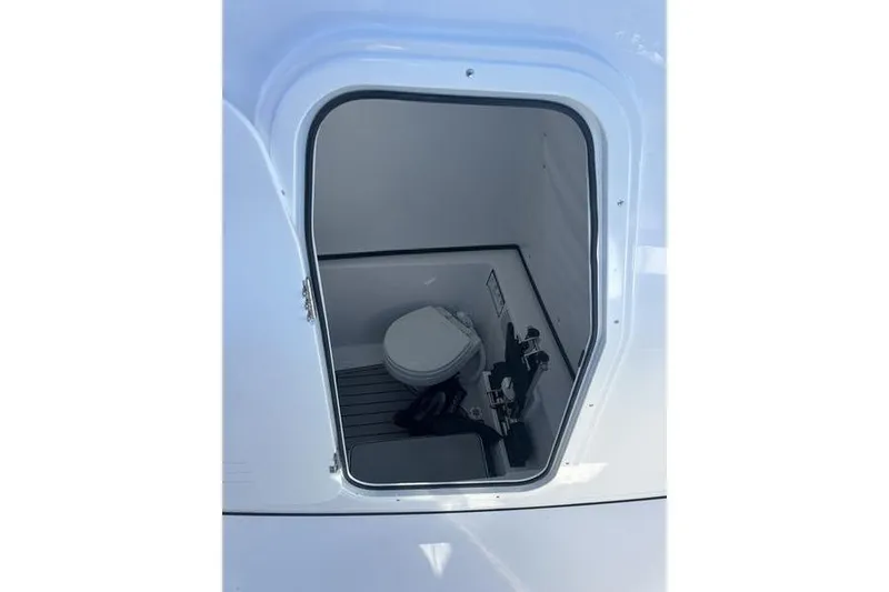Slide: The Image of 2026 Sportsman Open 282 Center Console boat interior with compact marine toilet. - 27