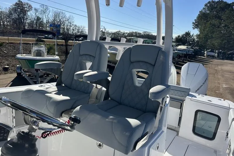 Slide: The Image of 2026 Sportsman Open 282 Center Console boat with dual captain's chairs and steering wheel. - 28