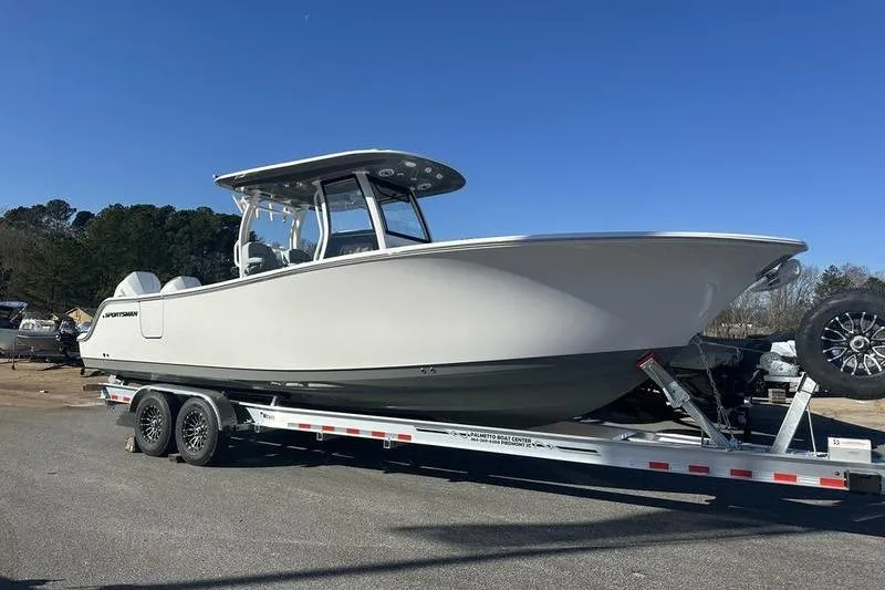 Slide: The Image of 2026 Sportsman Open 282 Center Console boat on trailer under clear blue sky. - 31