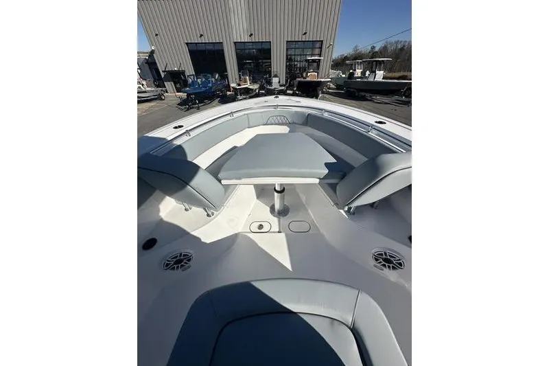 Slide: The Image of 2026 Sportsman Open 282 Center Console boat interior with seating and table. - 35