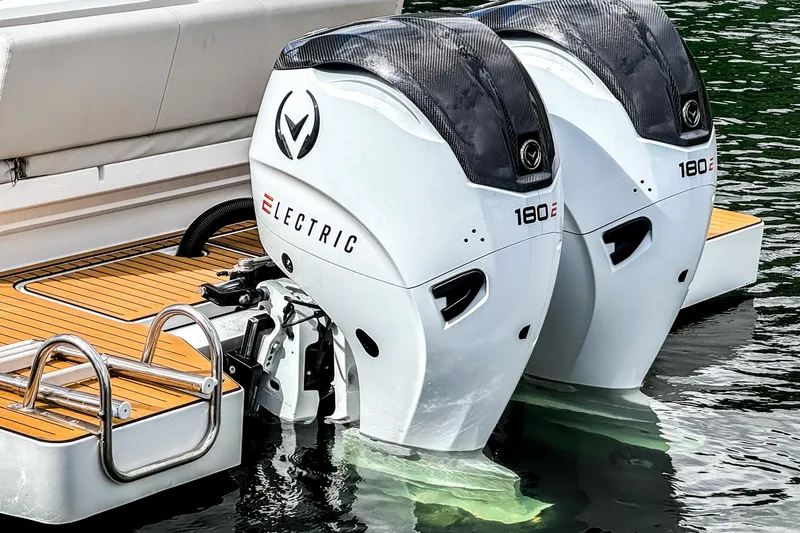 Slide: The Image of Twin electric outboard motors on a 2025 STERK 31 boat, docked on water. - 4