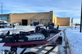 Slide: The Image of 2018 Ranger RT198P boat parked on snowy pavement near a large building. - 3