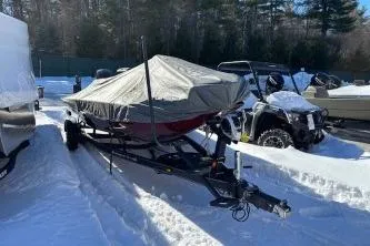 Slide: The Image of 2018 Ranger RT198P boat covered in snow, parked beside an ATV. - 8