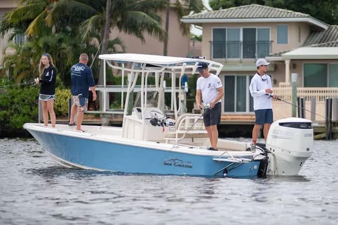 Slide: The Image of Manufacturer Provided Image: 2026 Sea Chaser 23 LX boat cruising near waterfront homes. - 4