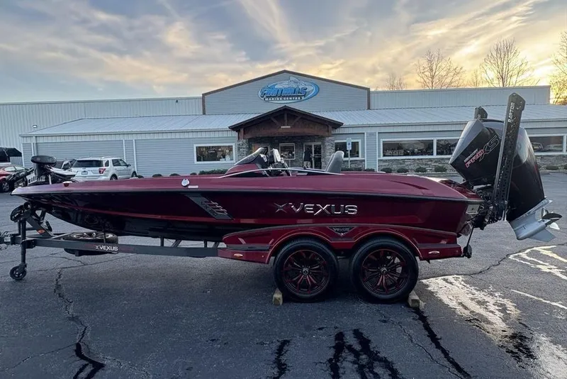 The Image of 2021 Vexus VX20 boat on trailer, parked outside a dealership at sunset. - 1