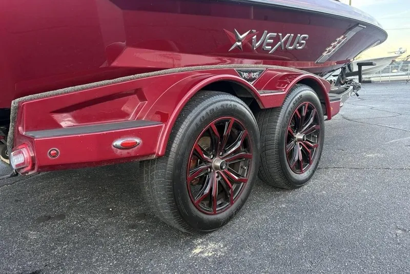 Slide: The Image of 2021 Vexus VX20 boat trailer with stylish red wheels and sleek design. - 10