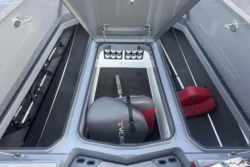 Slide: The Image of 2021 Vexus VX20 boat storage compartments with organized fishing gear and seating. - 20