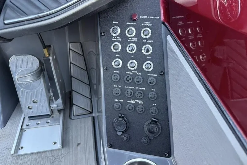 Slide: The Image of Control panel of a 2021 Vexus VX20 boat with various switches and buttons. - 21