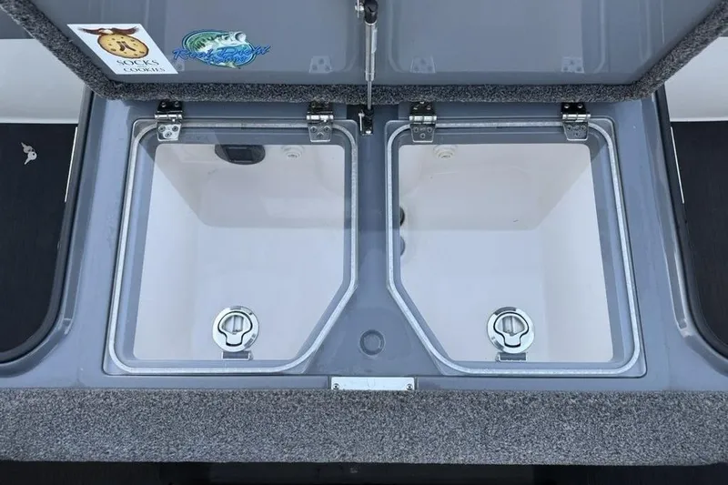 Slide: The Image of 2021 Vexus VX20 boat storage compartments with secure latches and interior view. - 28