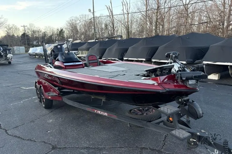 Slide: The Image of 2021 Vexus VX20 boat in a parking lot, featuring a sleek red design. - 5