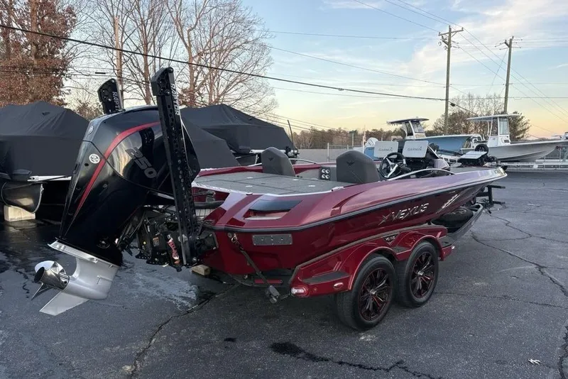 Slide: The Image of 2021 Vexus VX20 boat with powerful outboard motor, parked outdoors. - 6