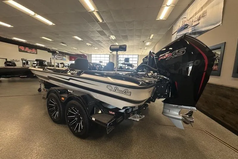 The Image of 2026 Bass Cat Lynx STS boat in showroom, featuring sleek design and powerful engine. - 0