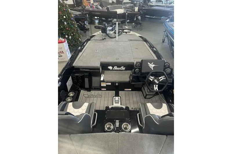 Slide: The Image of 2026 Bass Cat Lynx STS boat interior with steering wheel and seating. - 2