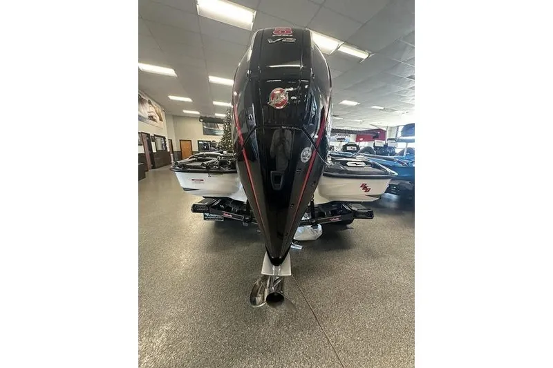 Slide: The Image of 2026 Bass Cat Lynx STS boat with powerful V8 engine in showroom. - 3