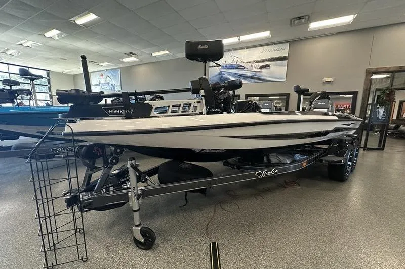 Slide: The Image of 2026 Bass Cat Lynx STS boat displayed indoors on a trailer. - 4