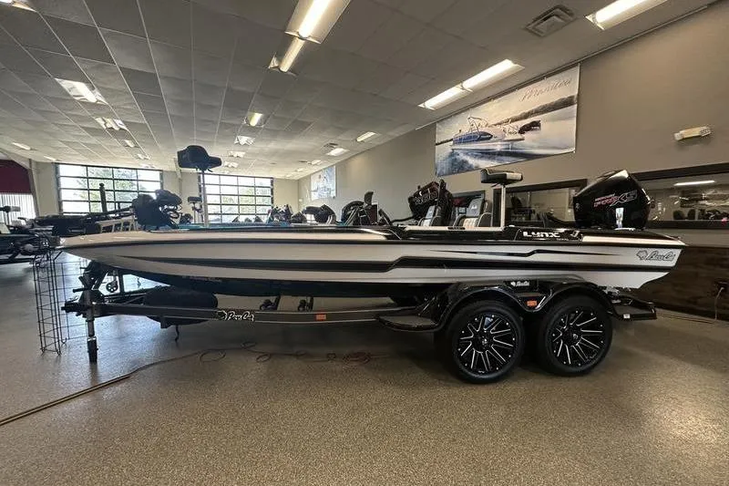 Slide: The Image of 2026 Bass Cat Lynx STS boat displayed indoors with sleek design and modern features. - 5