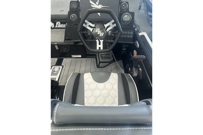 Slide: The Image of 2026 Bass Cat Lynx STS boat interior with steering wheel and hexagonal seat design. - 8