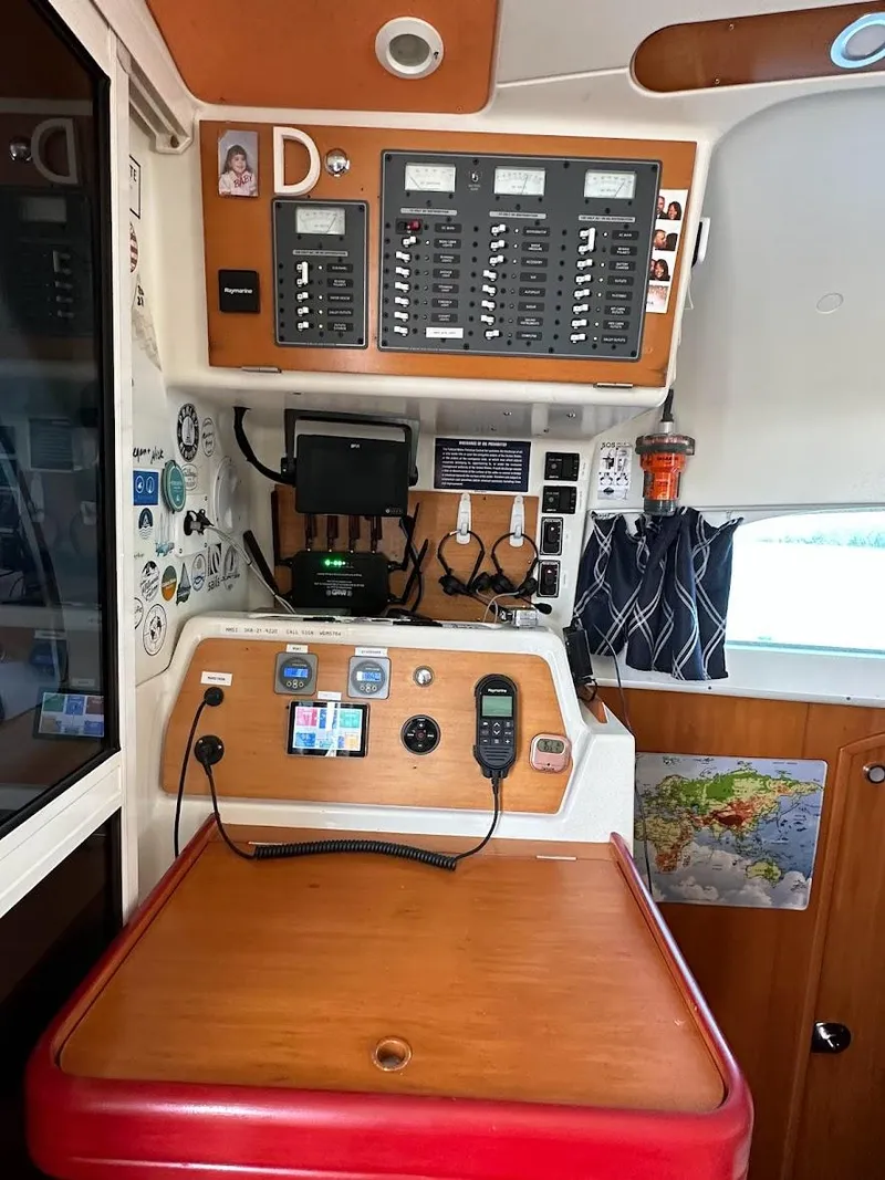 Slide: The Image of Control panel of a 2004 Lagoon 380 catamaran with navigation equipment and communication devices. - 17