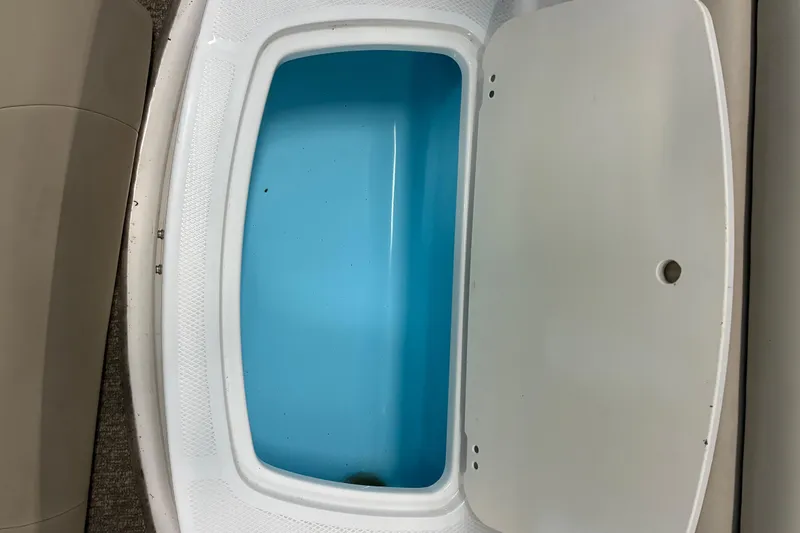 Slide: The Image of 2017 Chaparral 21 H2O Ski & Fish boat storage compartment with open lid. - 10