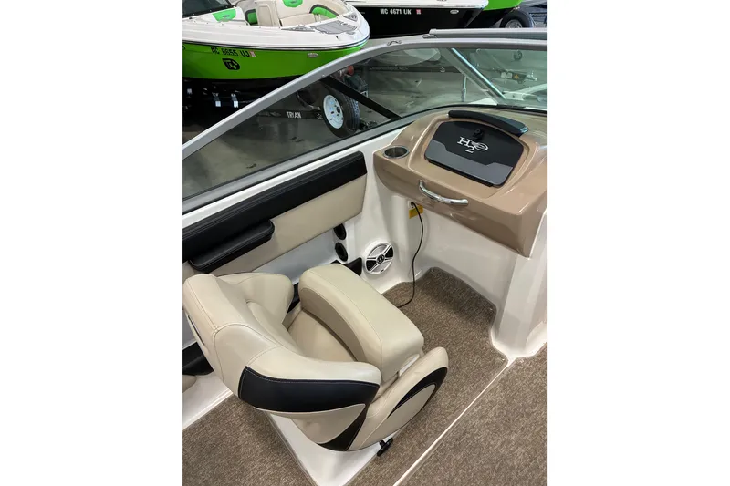 Slide: The Image of 2017 Chaparral 21 H2O Ski & Fish boat interior with beige seating and dashboard. - 6