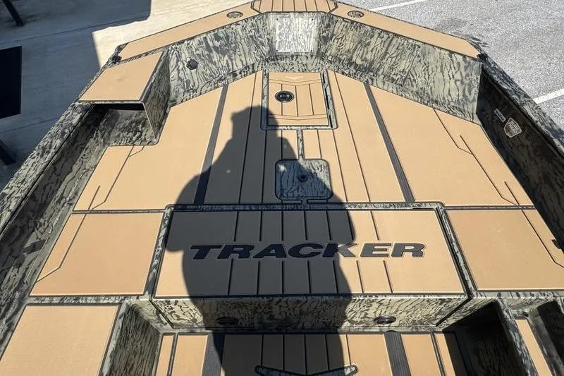 Slide: The Image of 2026 Tracker Grizzly 1756 T Marsh boat interior with camouflage design and shadow. - 11