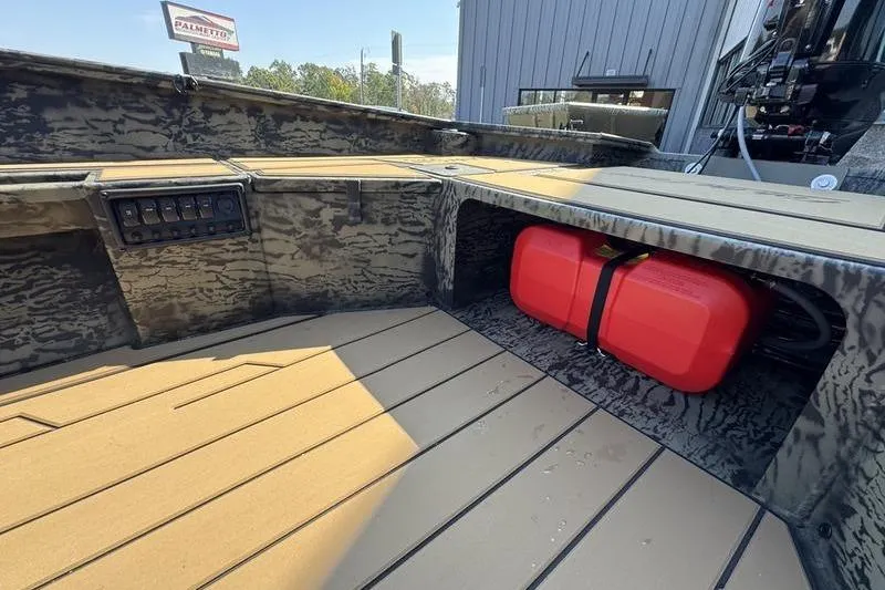 Slide: The Image of 2026 Tracker Grizzly 1756 T Marsh boat interior with red fuel tank and control panel. - 12