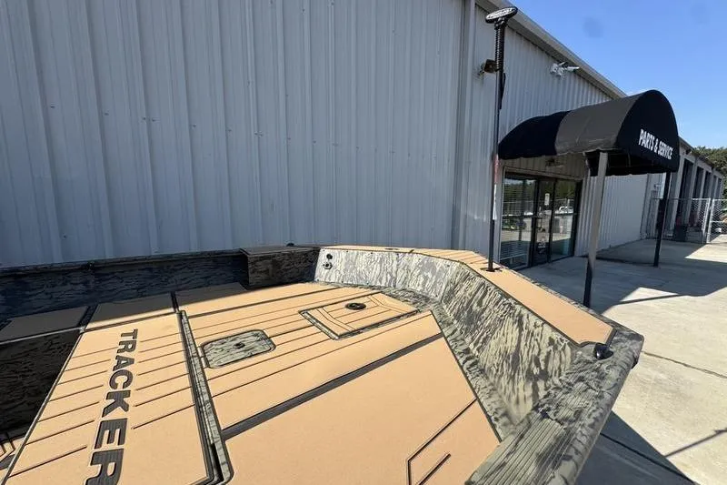 Slide: The Image of 2026 Tracker Grizzly 1756 T Marsh boat outside a service center. - 16