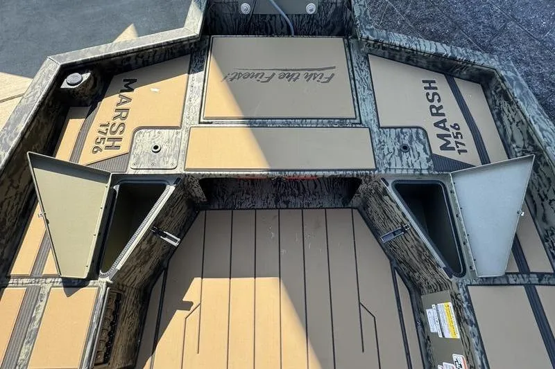 Slide: The Image of 2026 Tracker Grizzly 1756 T Marsh boat interior with storage compartments open. - 17