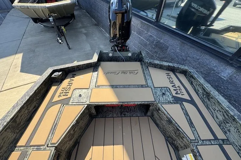 Slide: The Image of 2026 Tracker Grizzly 1756 T Marsh boat interior with camo design and motor. - 19