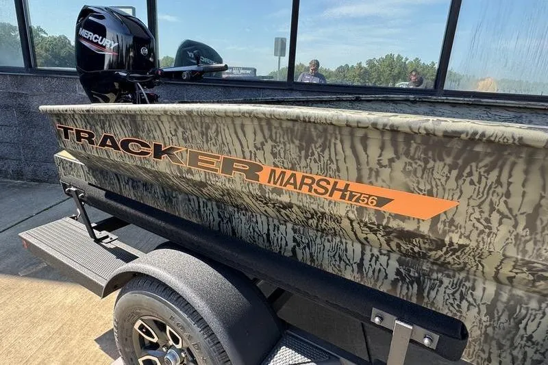 Slide: The Image of 2026 Tracker Grizzly 1756 T Marsh boat with camouflage design on a trailer. - 2