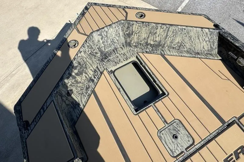 Slide: The Image of 2026 Tracker Grizzly 1756 T Marsh boat interior with camouflage design and storage compartment. - 21
