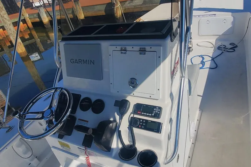 Slide: The Image of 2022 KenCraft BayRider 2460 boat console with Garmin navigation system and steering wheel. - 2