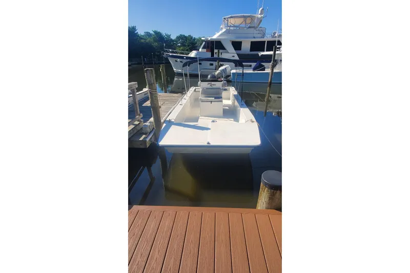 Slide: The Image of 2022 KenCraft BayRider 2460 boat docked in a marina under clear blue skies. - 3