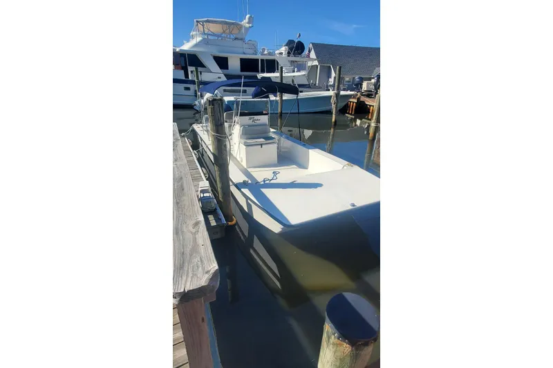Slide: The Image of 2022 KenCraft BayRider 2460 boat docked in marina under clear blue sky. - 8
