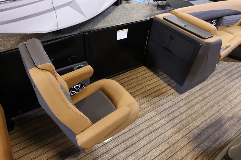 Slide: The Image of 2026 Harris Sunliner 230 Sport interior with tan and gray seating on wood-patterned flooring. - 10