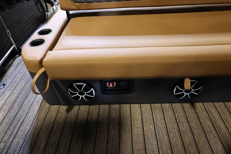 Slide: The Image of 2026 Harris Sunliner 230 Sport interior with tan seating, cup holders, and speakers. - 14