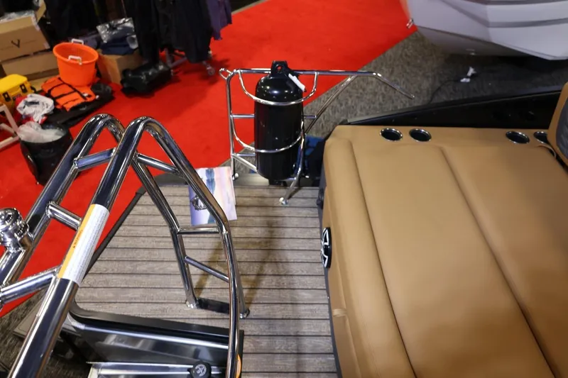 Slide: The Image of 2026 Harris Sunliner 230 Sport boat interior with tan seating and stainless steel railings. - 17