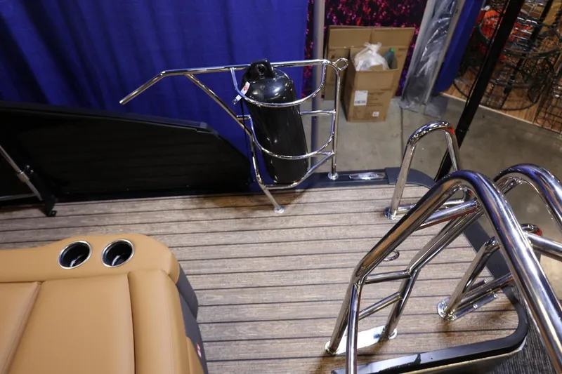 Slide: The Image of 2026 Harris Sunliner 230 Sport boat deck with seating, cup holders, and stainless steel railings. - 19