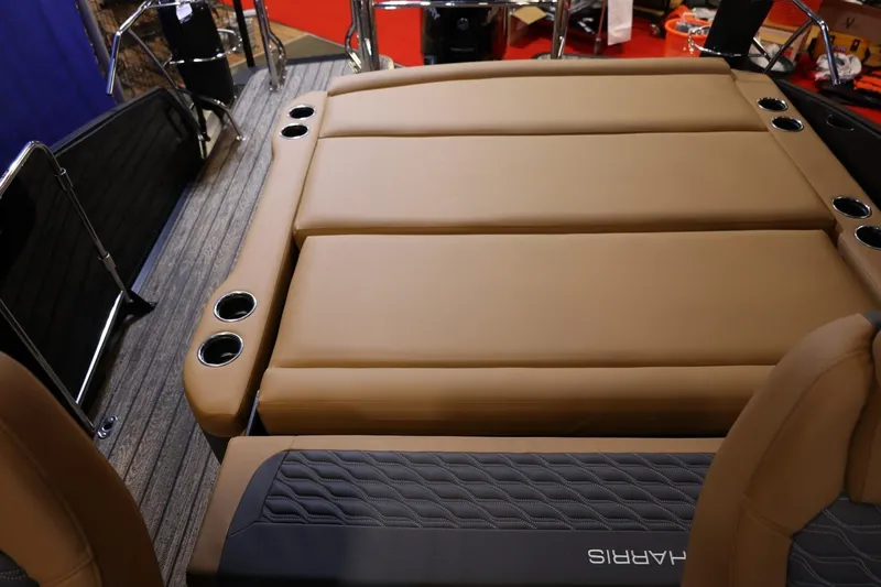 Slide: The Image of 2026 Harris Sunliner 230 Sport boat interior with tan seating and cup holders. - 23