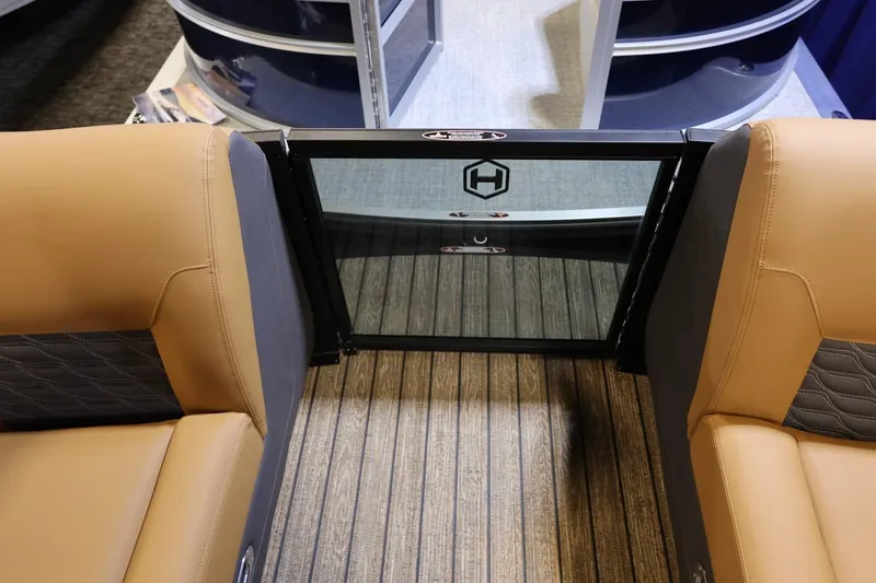 Slide: The Image of 2026 Harris Sunliner 230 Sport interior with tan seating and glass door. - 26