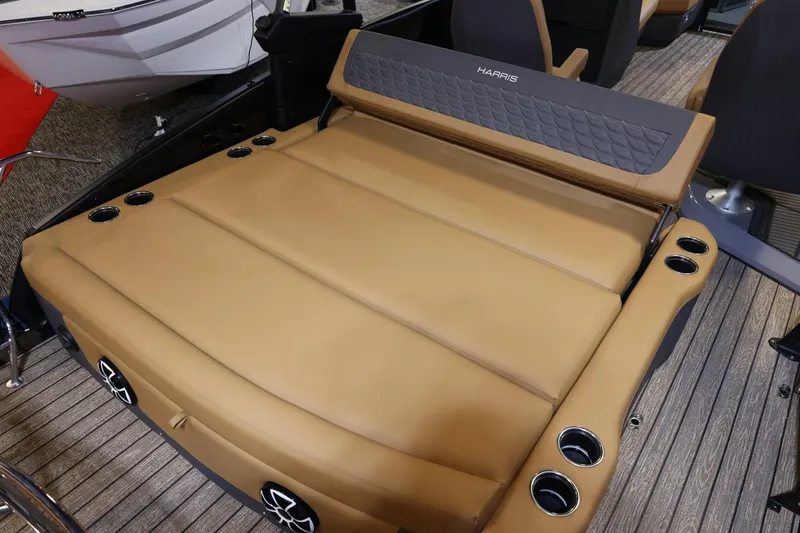 Slide: The Image of 2026 Harris Sunliner 230 Sport boat interior with tan seating and cup holders. - 29
