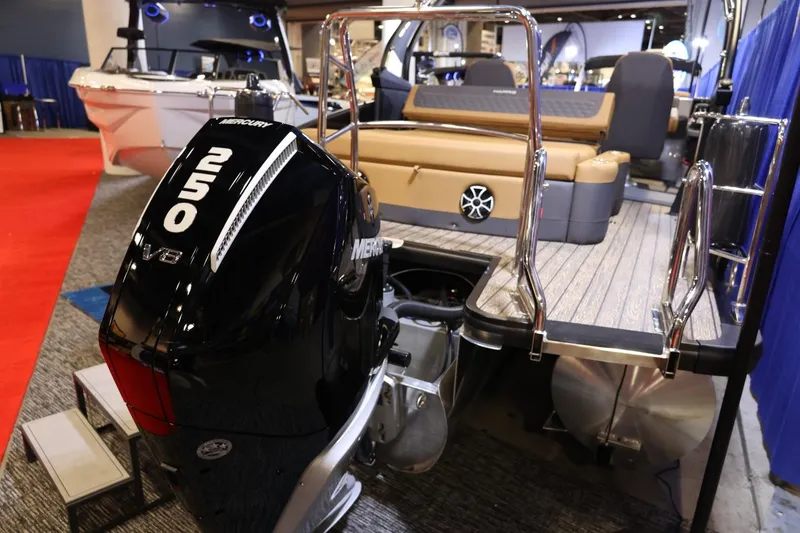 Slide: The Image of 2026 Harris Sunliner 230 Sport with Mercury 250 V8 engine at a boat show. - 31