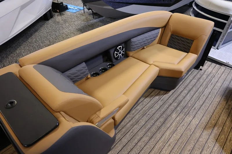 Slide: The Image of Luxurious seating on 2026 Harris Sunliner 230 Sport boat, featuring tan and gray upholstery. - 5