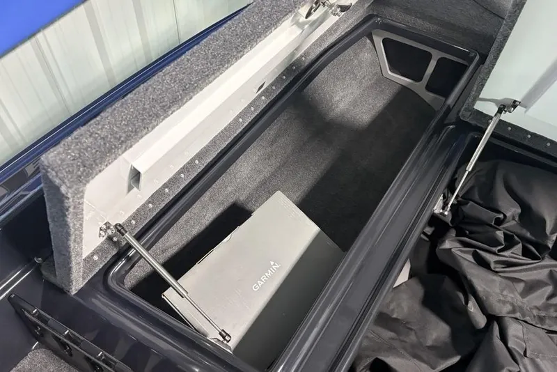 Slide: The Image of Open storage compartment in 2026 Phoenix 919 ZXL, featuring a Garmin box inside. - 11
