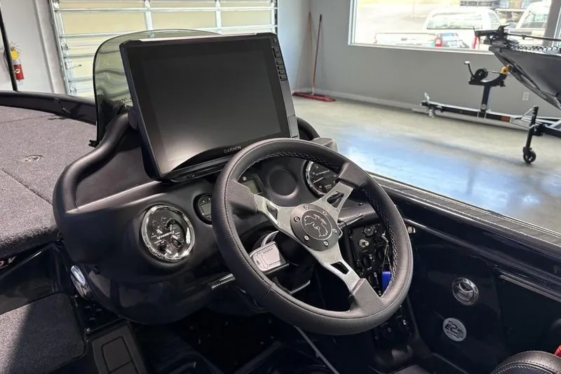 Slide: The Image of Steering console of 2026 Phoenix 919 ZXL boat with Garmin display in a garage setting. - 19