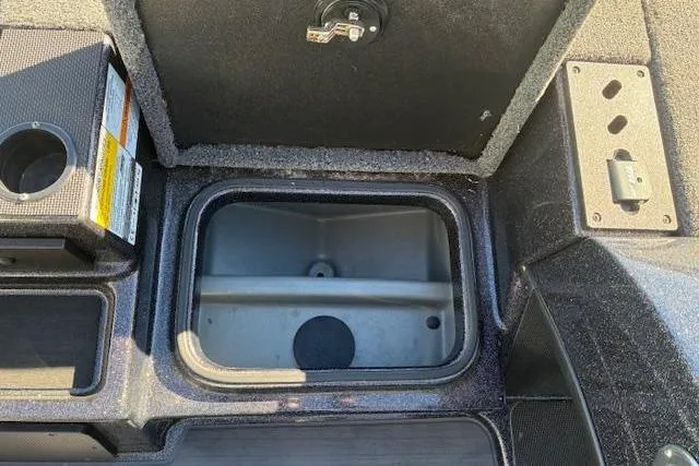 Slide: The Image of 2022 Triton 18 TrX boat storage compartment with open lid, showcasing interior space. - 10