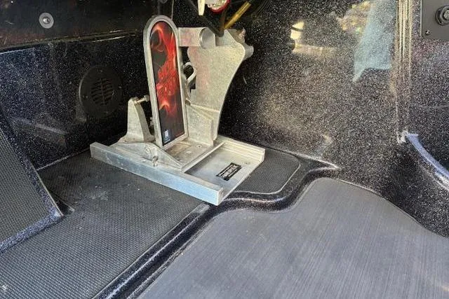 Slide: The Image of 2022 Triton 18 TrX boat interior with metal foot pedal and textured flooring. - 12