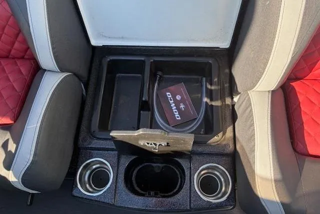 Slide: The Image of 2022 Triton 18 TrX boat interior with storage compartment and cup holders. - 13